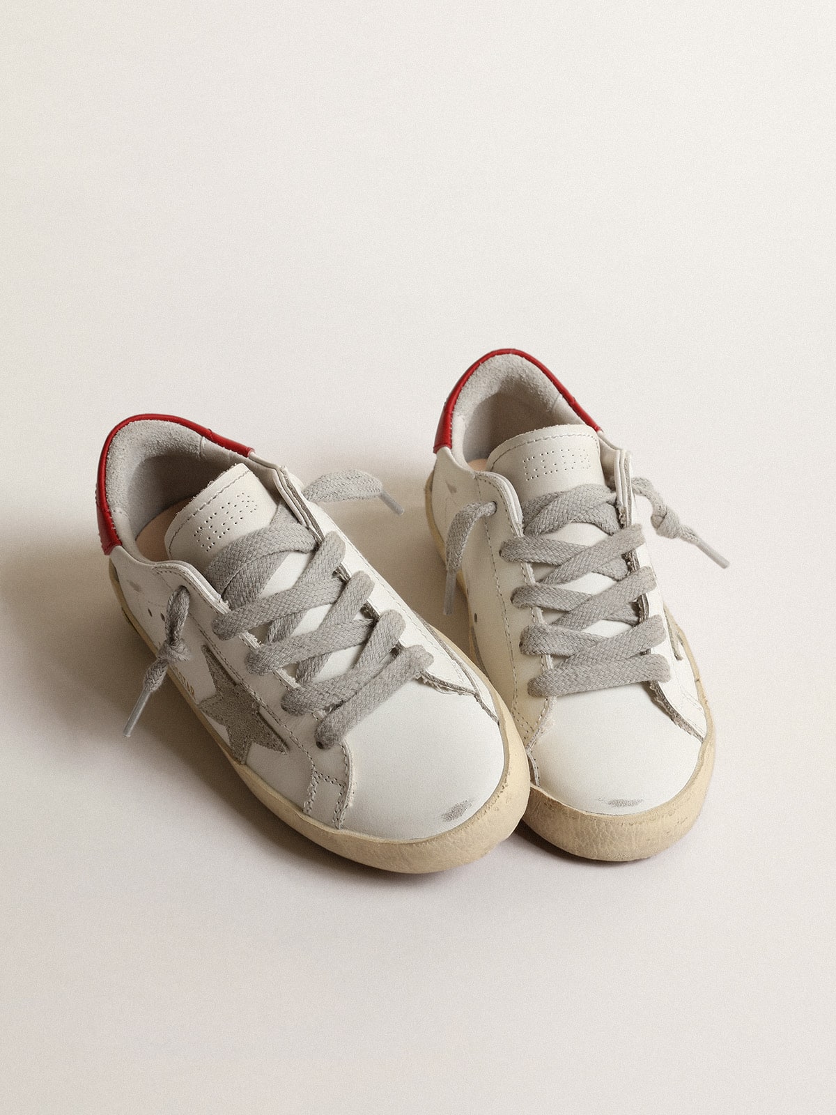Super-Star Young with suede star and red leather on the heel
