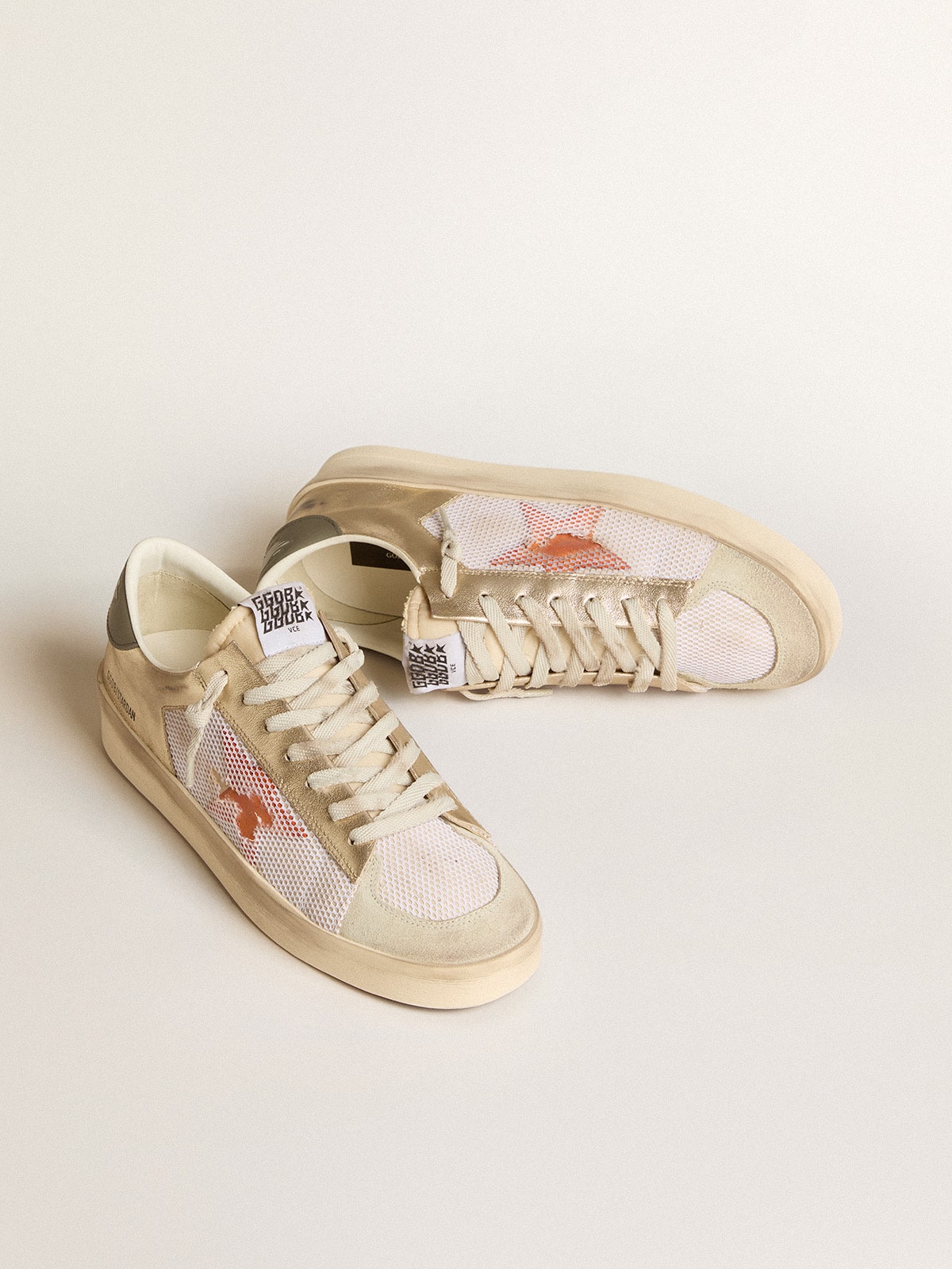 Stardan in white mesh with orange star and platinum leather details