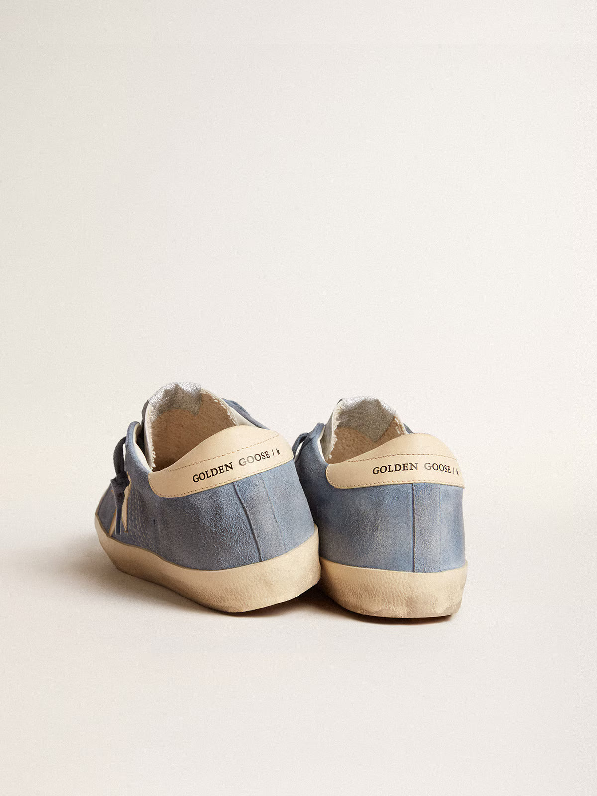 Azure blue suede with a star and heel in beige leather