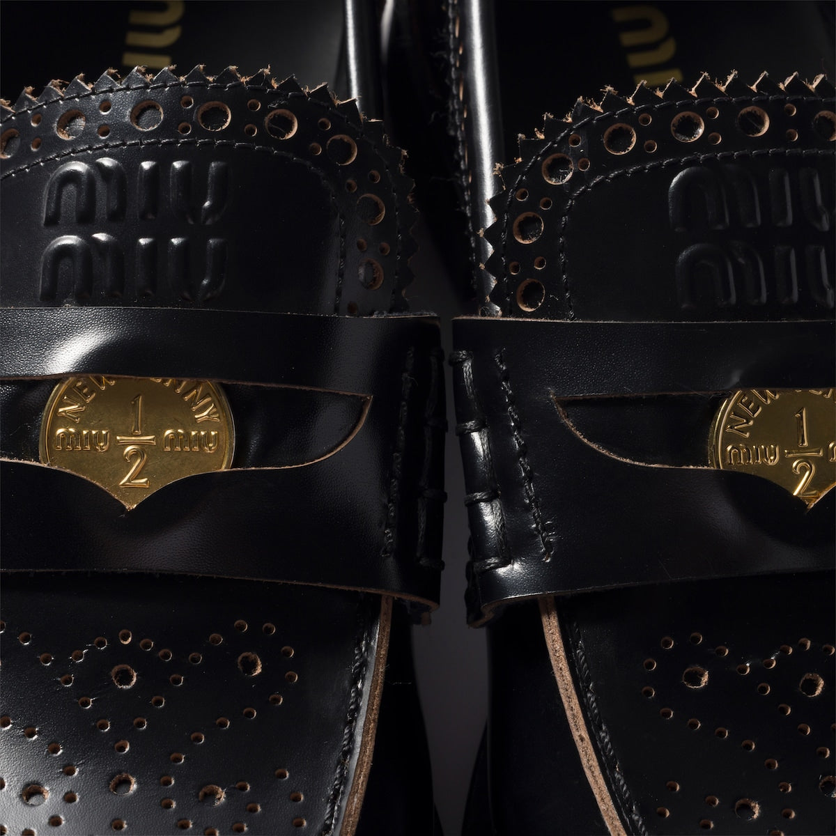 Leather loafers in black with gold-colored coin detail
