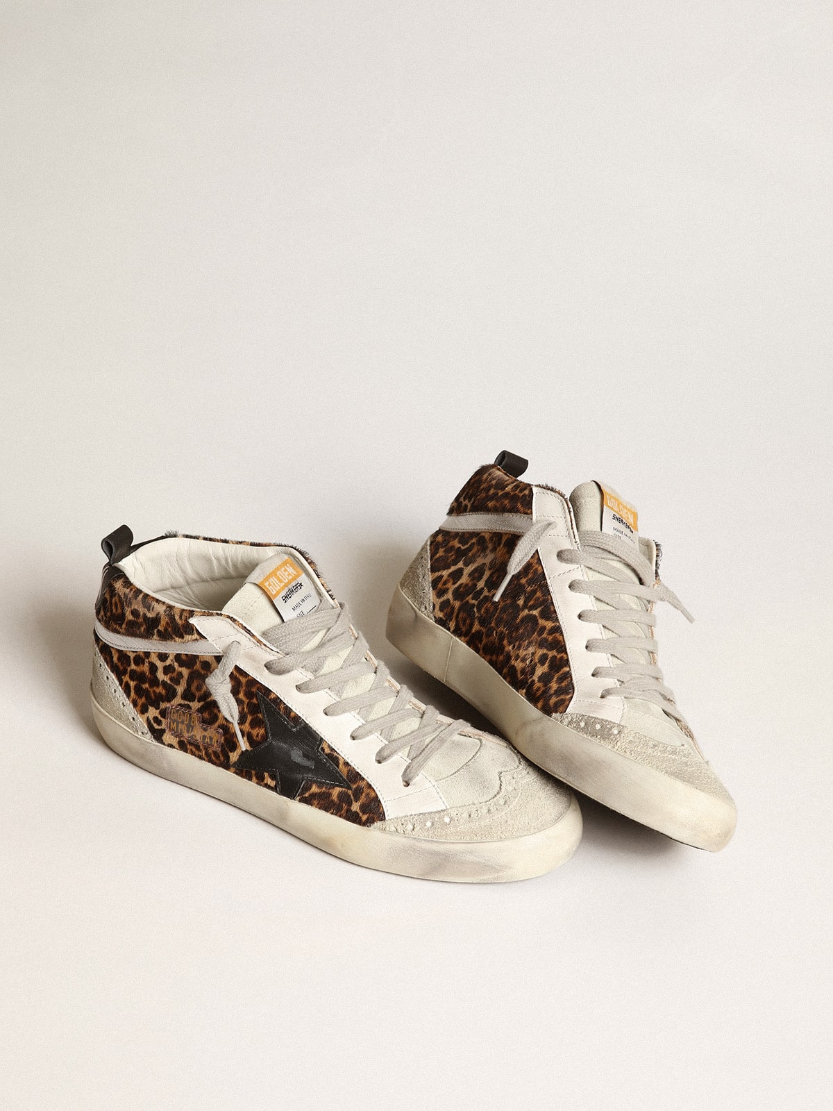 Mid Star made of pony fur with leopard print and black leather star and silver comma