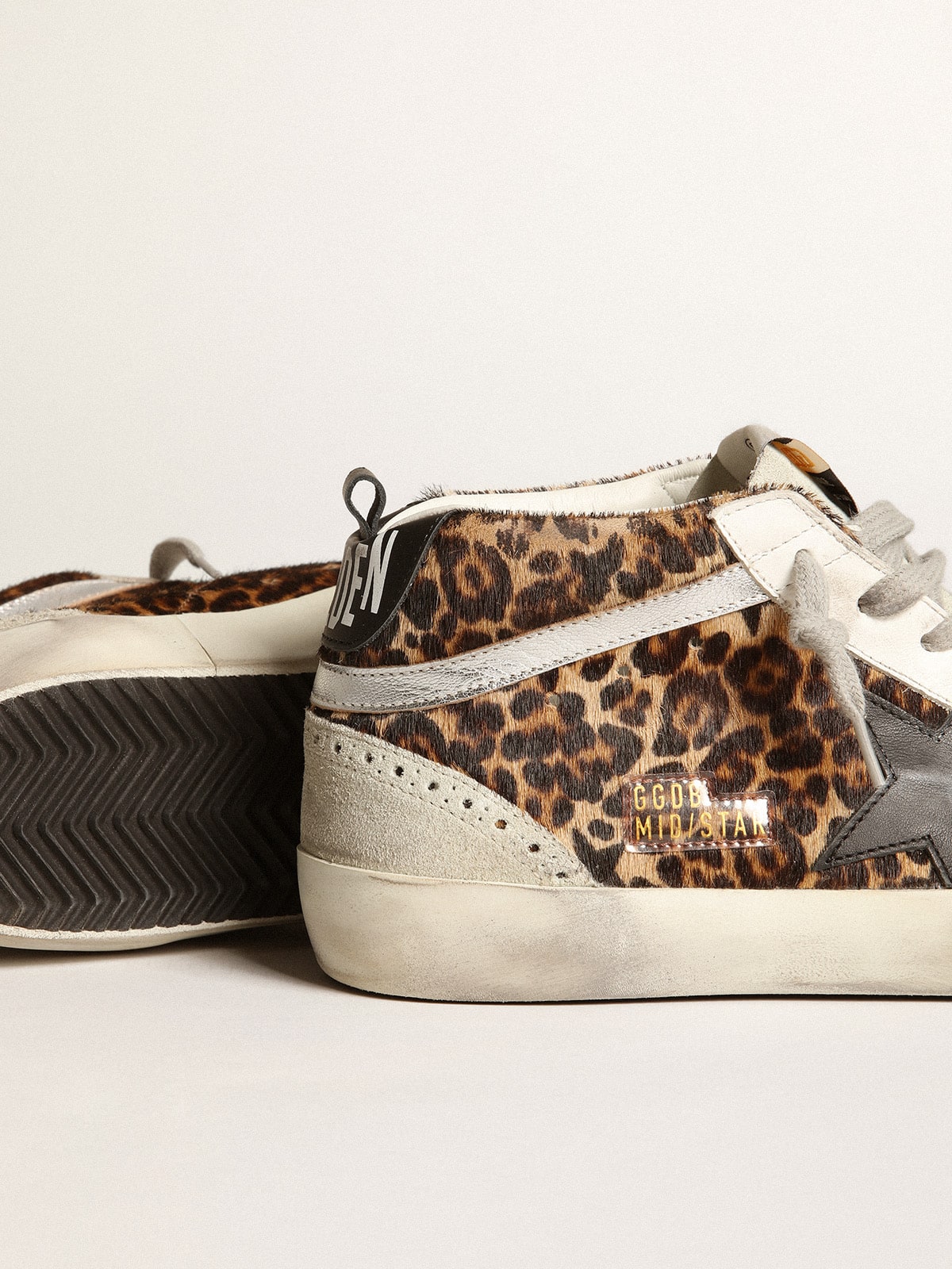 Mid Star made of pony fur with leopard print and black leather star and silver comma