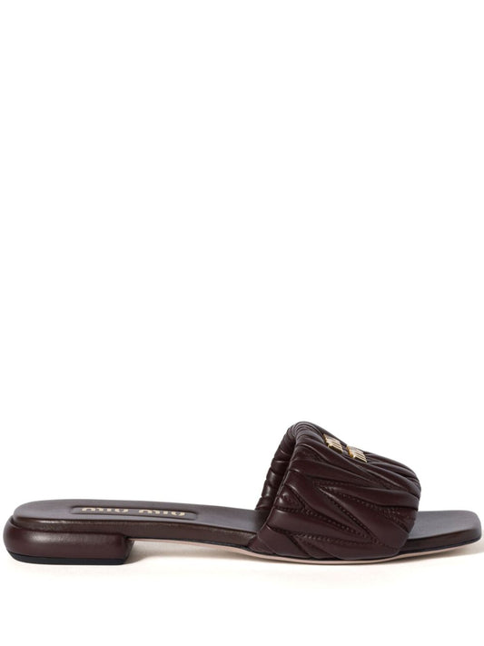 Slides made of matelassed leather in black