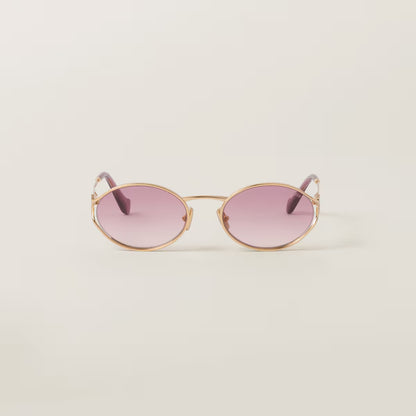Sunglasses with a gold frame and pink gradient lenses