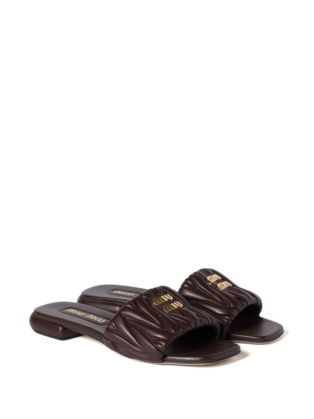 Slides made of matelassed leather in black