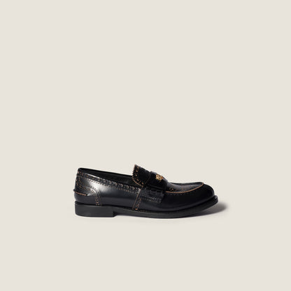 Leather loafers in black with gold-colored coin detail