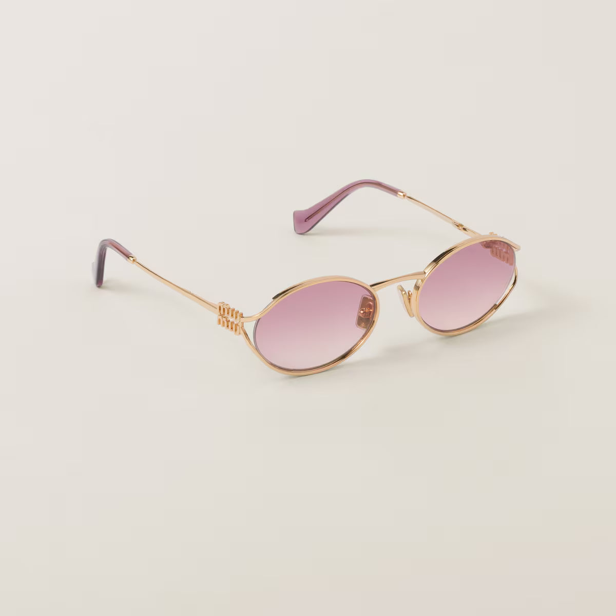 Sunglasses with a gold frame and pink gradient lenses