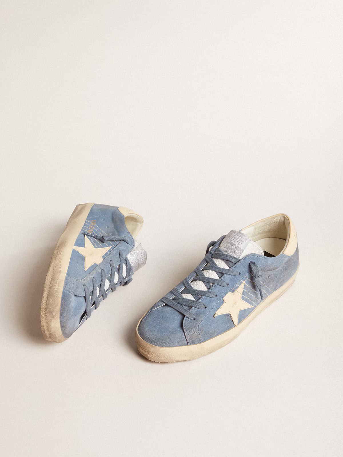 Azure blue suede with a star and heel in beige leather