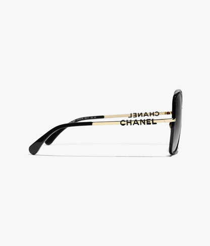 Butterfly-Sonnenbrille mit gold- und schwarzfarbenem Metallgestell und grau verlaufenden Gläsern