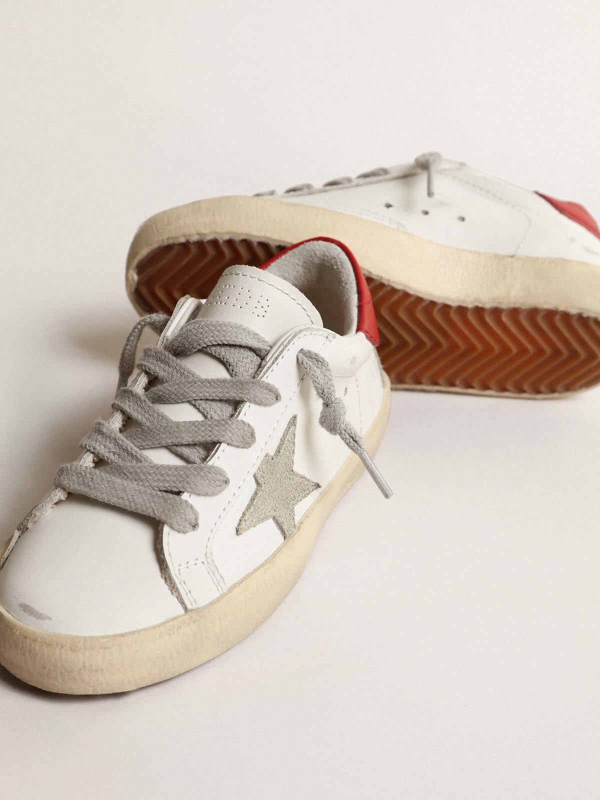 Super-Star Young with suede star and red leather on the heel