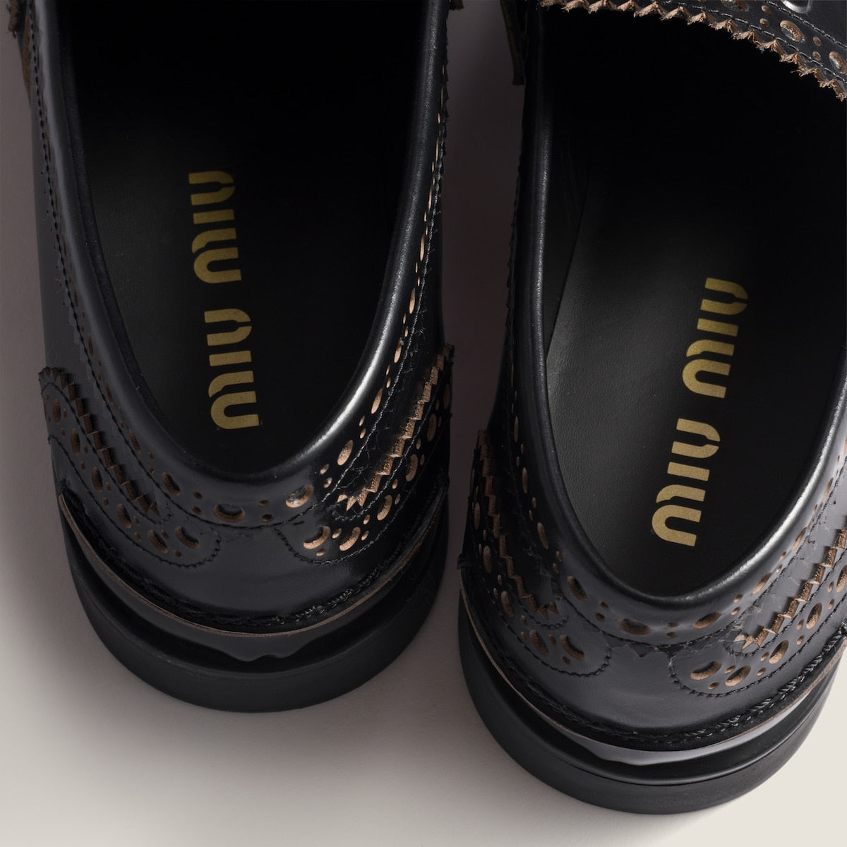 Leather loafers in black with gold-colored coin detail