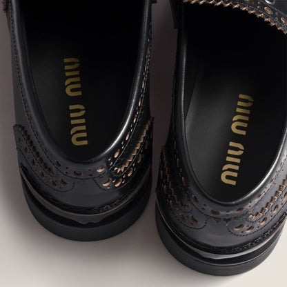 Leather loafers in black with gold-colored coin detail