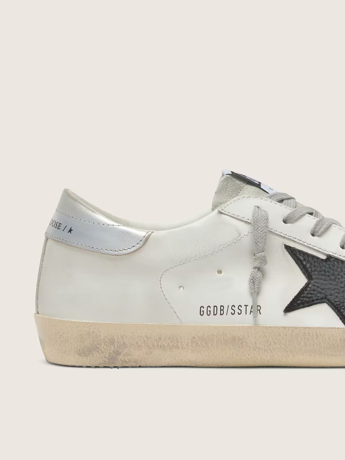 White leather with a black nubuck leather star and silver metallic leather heel
