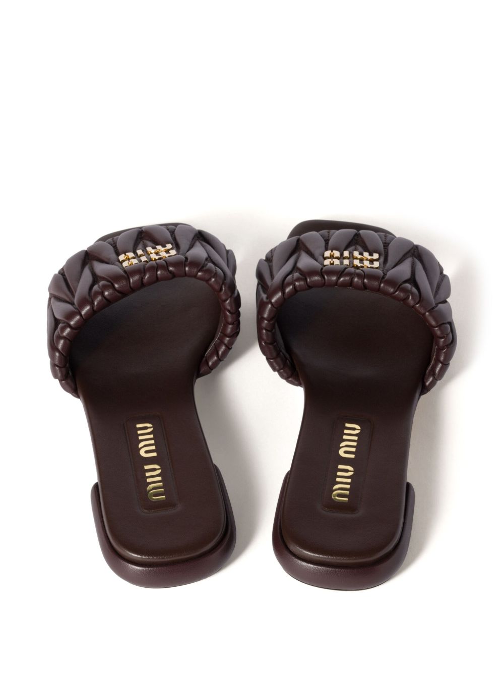 Slides made of matelassed leather in black