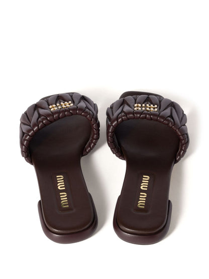 Slides made of matelassed leather in black