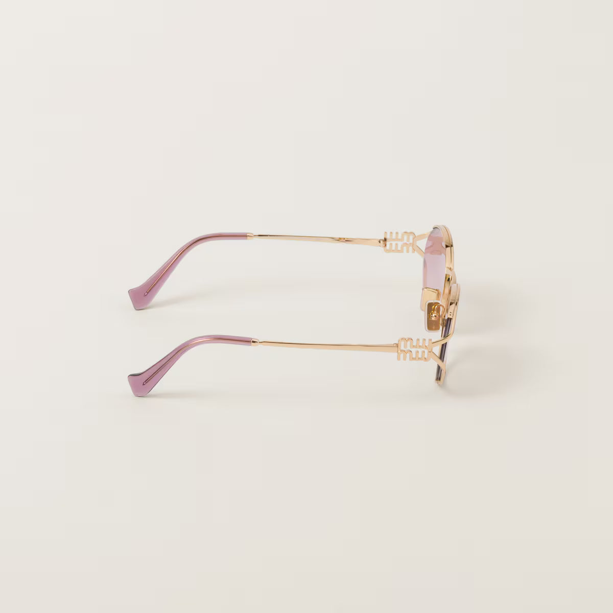 Sunglasses with a gold frame and pink gradient lenses