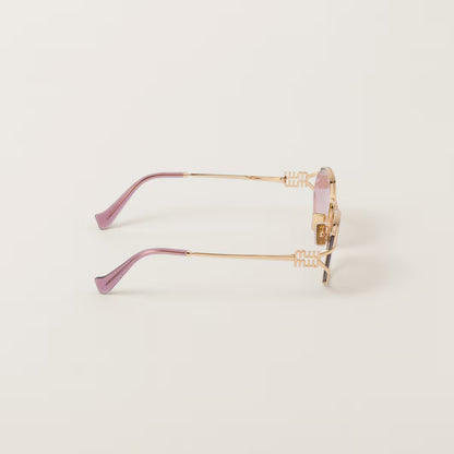 Sunglasses with a gold frame and pink gradient lenses