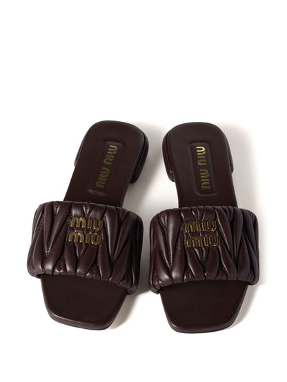 Slides made of matelassed leather in black
