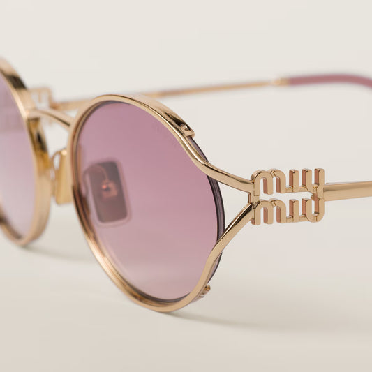 Sunglasses with a gold frame and pink gradient lenses
