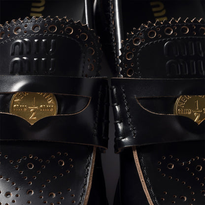Leather loafers in black with gold-colored coin detail