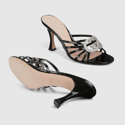Women's heeled slider sandals with GG crystal-embellished cross straps in black patent leather