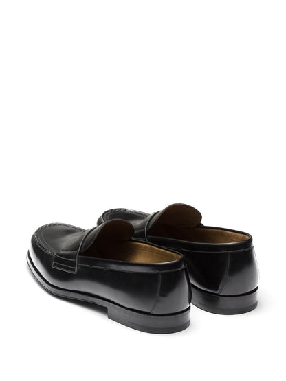 Black leather slipper with logo and plate