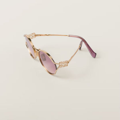 Sunglasses with a gold frame and pink gradient lenses