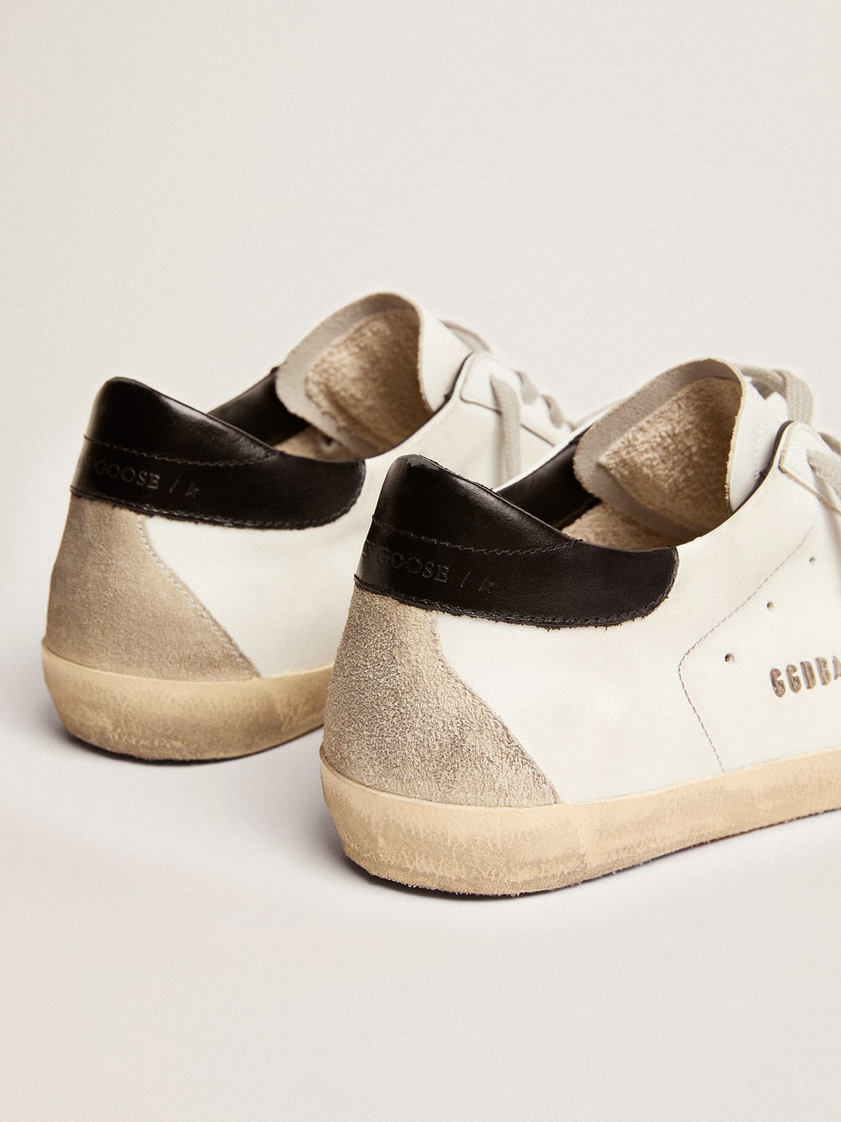 Super-Star with black heel and metal stud lettering