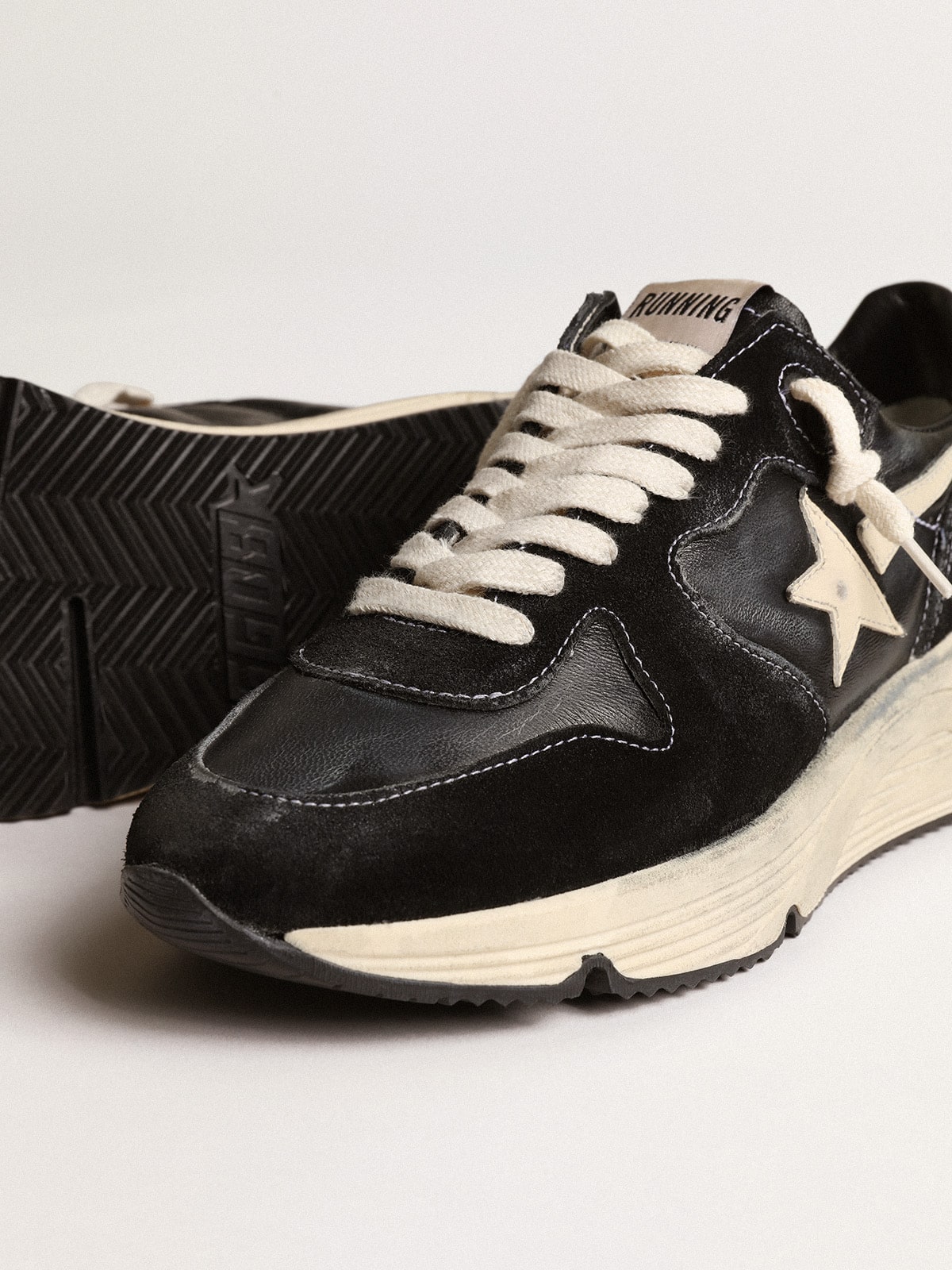 Running sole made of black nappa and suede